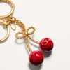 Chez Valentino Metal And Enamel Bag Charm With Key Ring