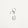 Coeur Hyperbole Bag Charm With Key Chain In Metal, Synthetic Material, And Crystals