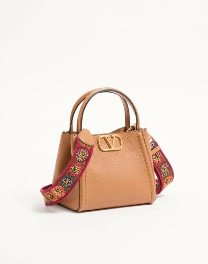 Valentino Garavani Alltime small handbag in grainy calfskin with embroidered ribbon shoulder strap
