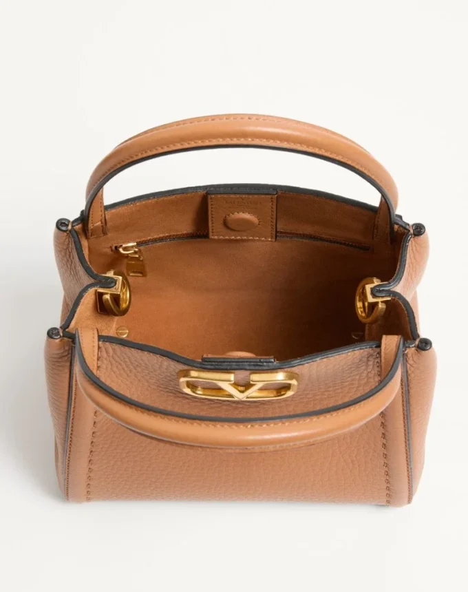 Valentino Garavani Alltime small handbag in grainy calfskin with embroidered ribbon shoulder strap