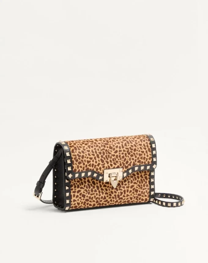 Valentino Garavani Rockstud small shoulder bag in pony-effect calfskin with animal print