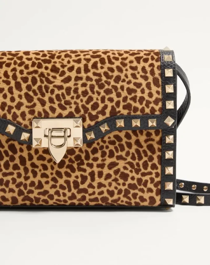 Valentino Garavani Rockstud small shoulder bag in pony-effect calfskin with animal print